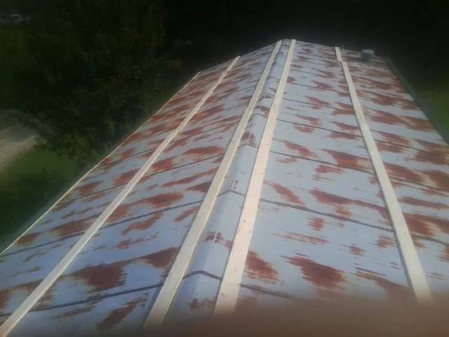 Rusted metal roof panels with new wood purlins before replacement — Storm Damage Roof Repair in Burlingame by Roofing Brothers
