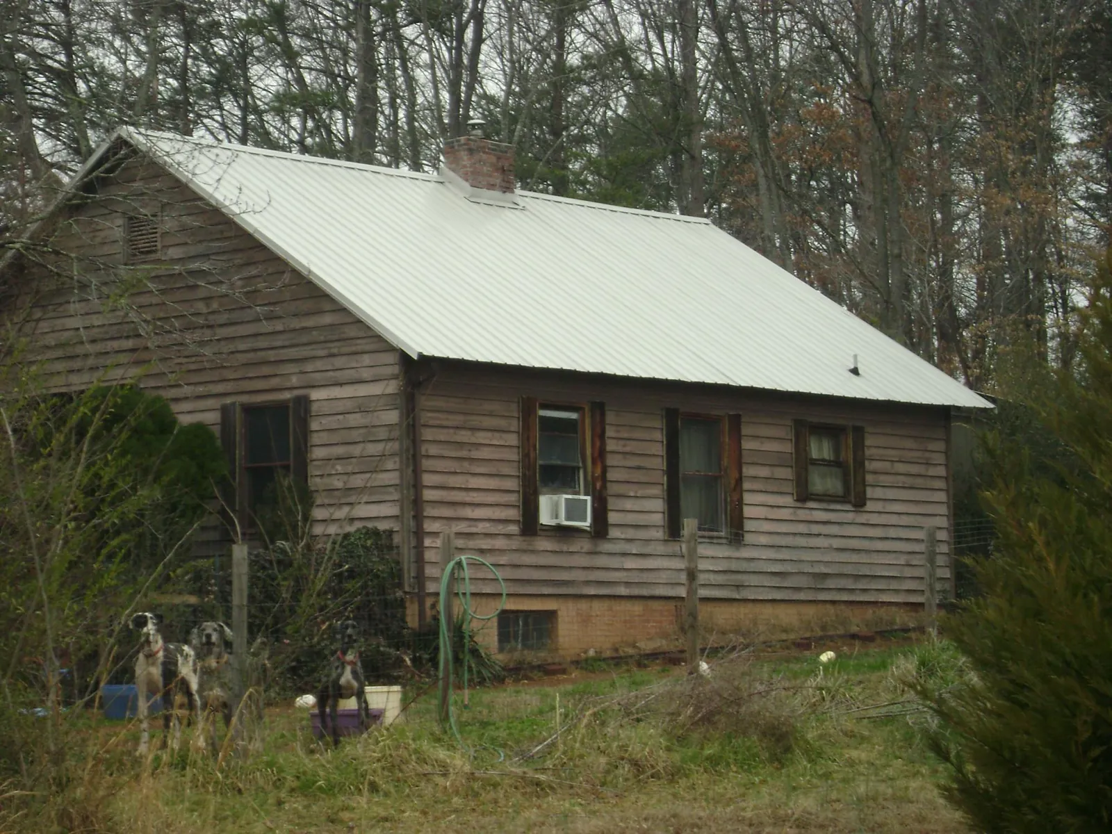 White metal roof on an old wood sided farmhouse, from a Metal Roof Installation job in Burlingame